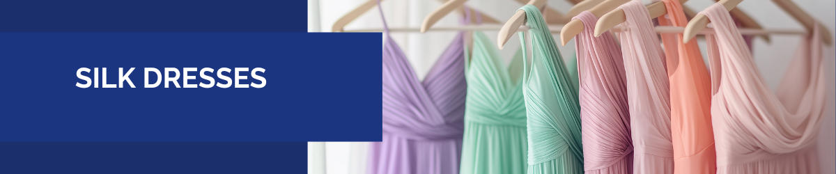 Silk dresses in soft pastel colors hanging on clothing racks.